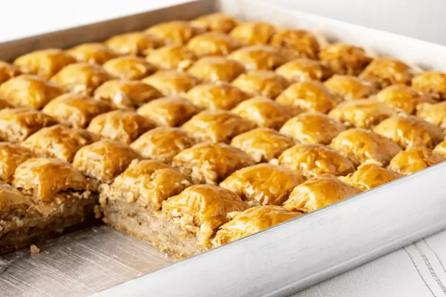 dikdörtgen tepsi içinde kare dilimlenmiş cevizli baklava