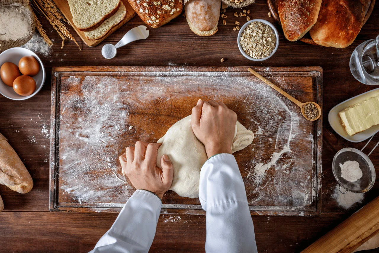 Şefin mutfakta el yapımı artisan ekmek hamuru yoğurması